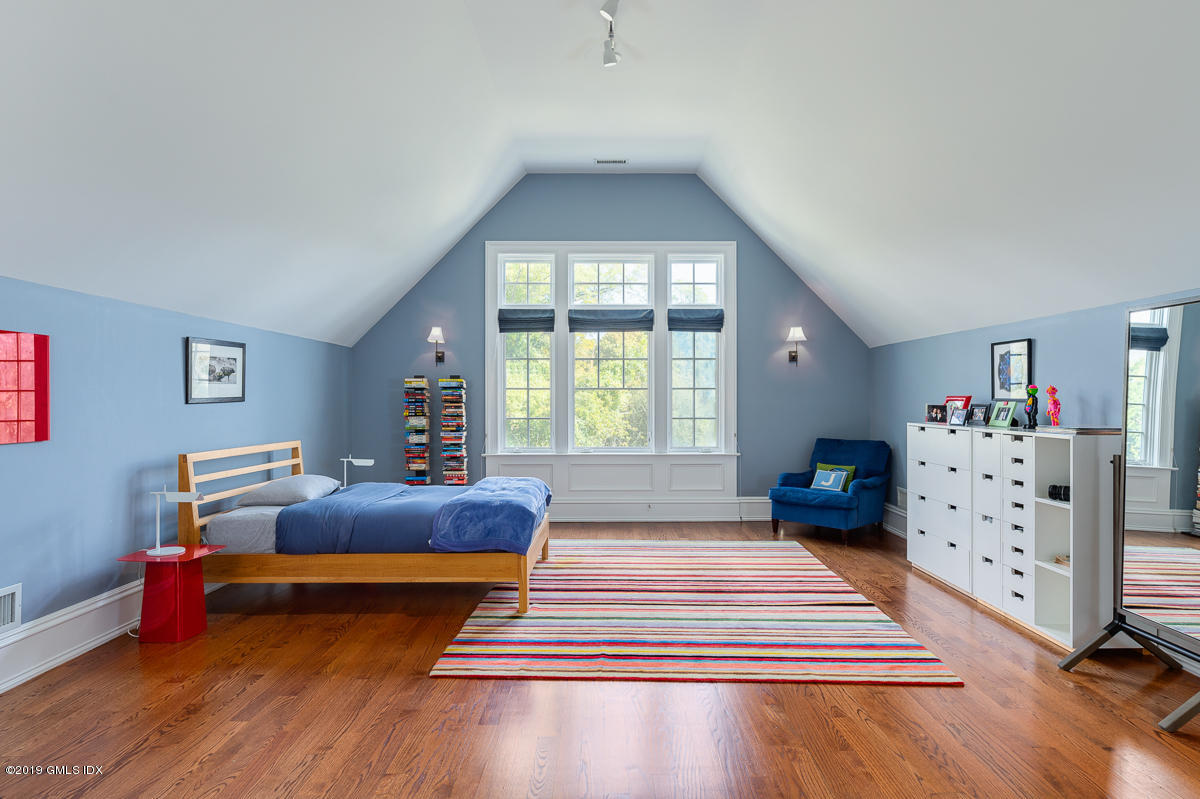 170 Old Mill Road Greenwich, CT 06831 - Photo 25 of 42 a bedroom with a bed and wooden floor