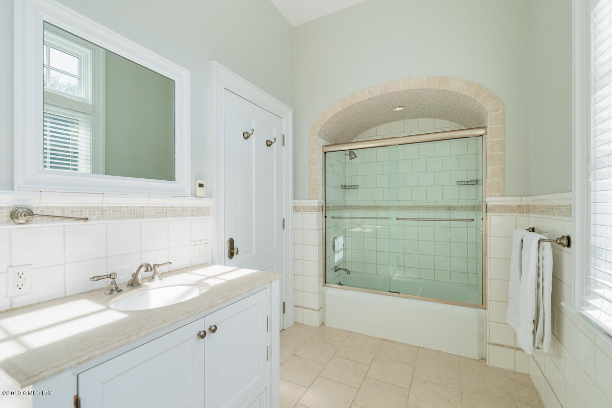 170 Old Mill Road Greenwich, CT 06831 - Photo 26 of 42 a bathroom with a granite countertop sink mirror and shower