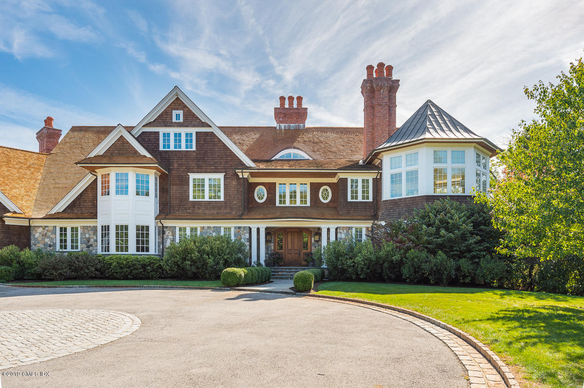 170 Old Mill Road Greenwich, CT 06831 - Photo 3 of 42 a front view of a house with a yard and trees