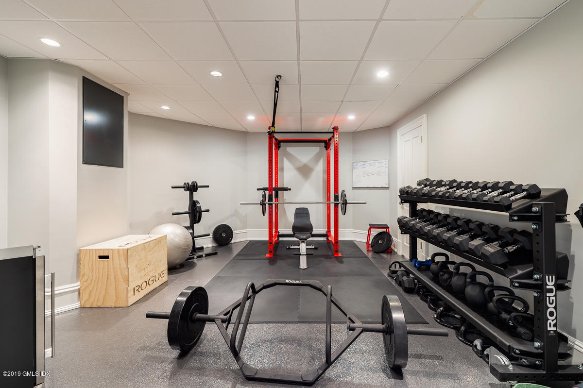 170 Old Mill Road Greenwich, CT 06831 - Photo 33 of 42 a room with gym equipment and wooden floor