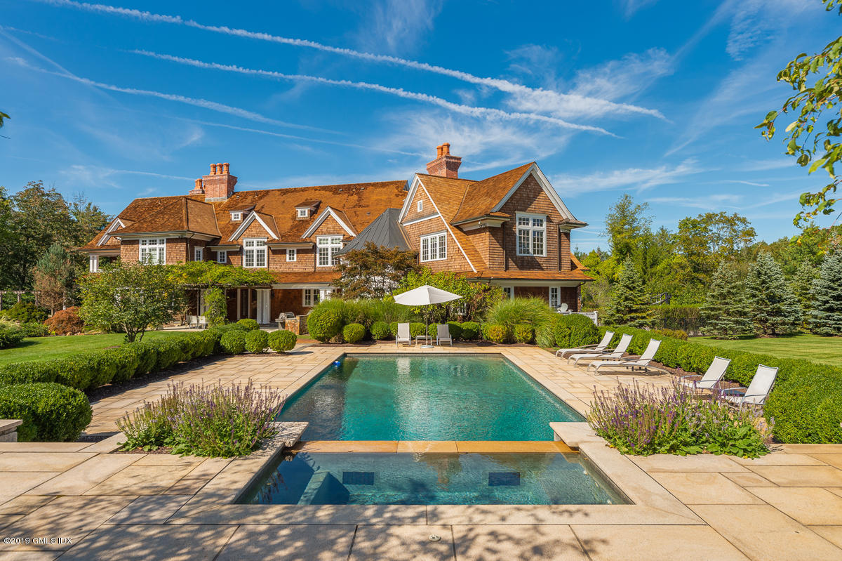 170 Old Mill Road Greenwich, CT 06831 - Photo 34 of 42 a view of a white house with a yard and potted plants