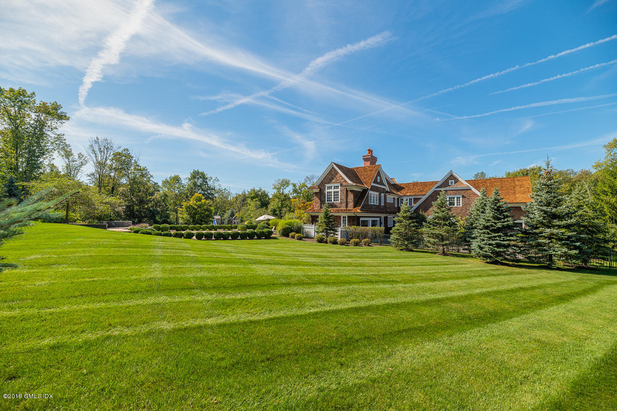 170 Old Mill Road Greenwich, CT 06831 - Photo 37 of 42 a front view of a house with a garden