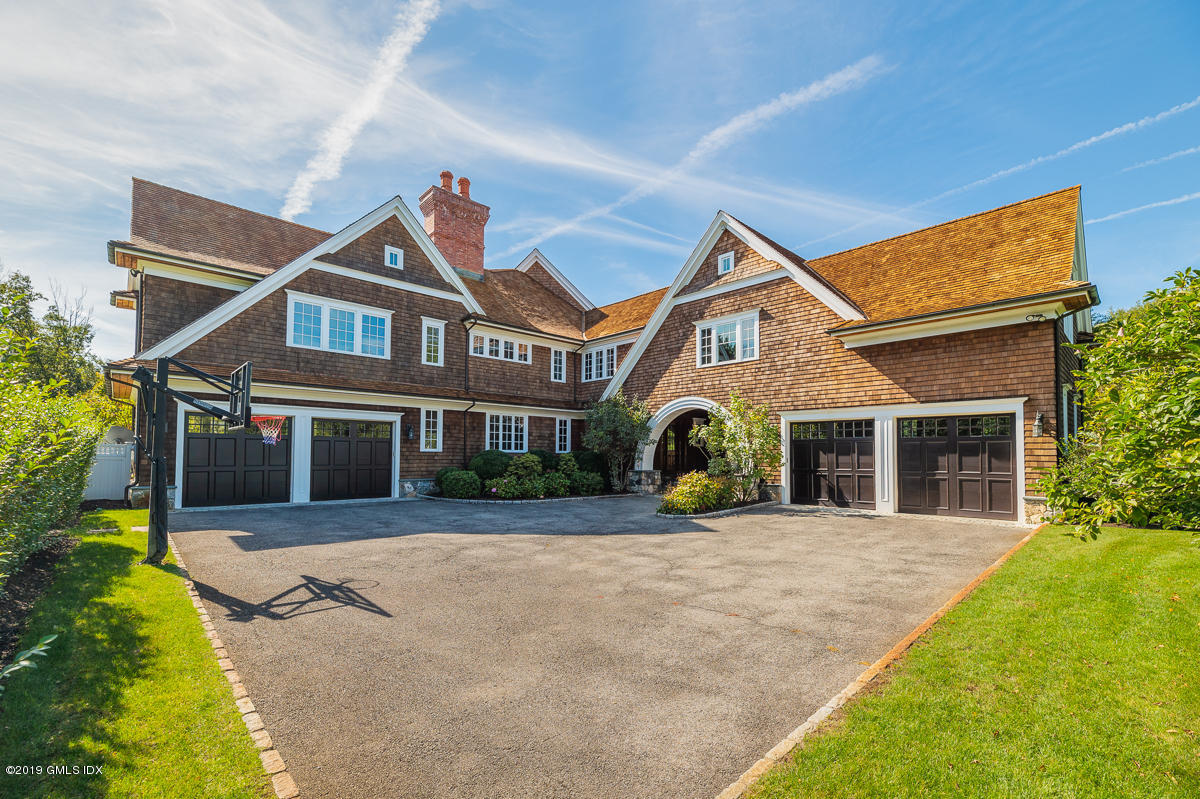 170 Old Mill Road Greenwich, CT 06831 - Photo 38 of 42 a front view of a house with a yard and potted plants