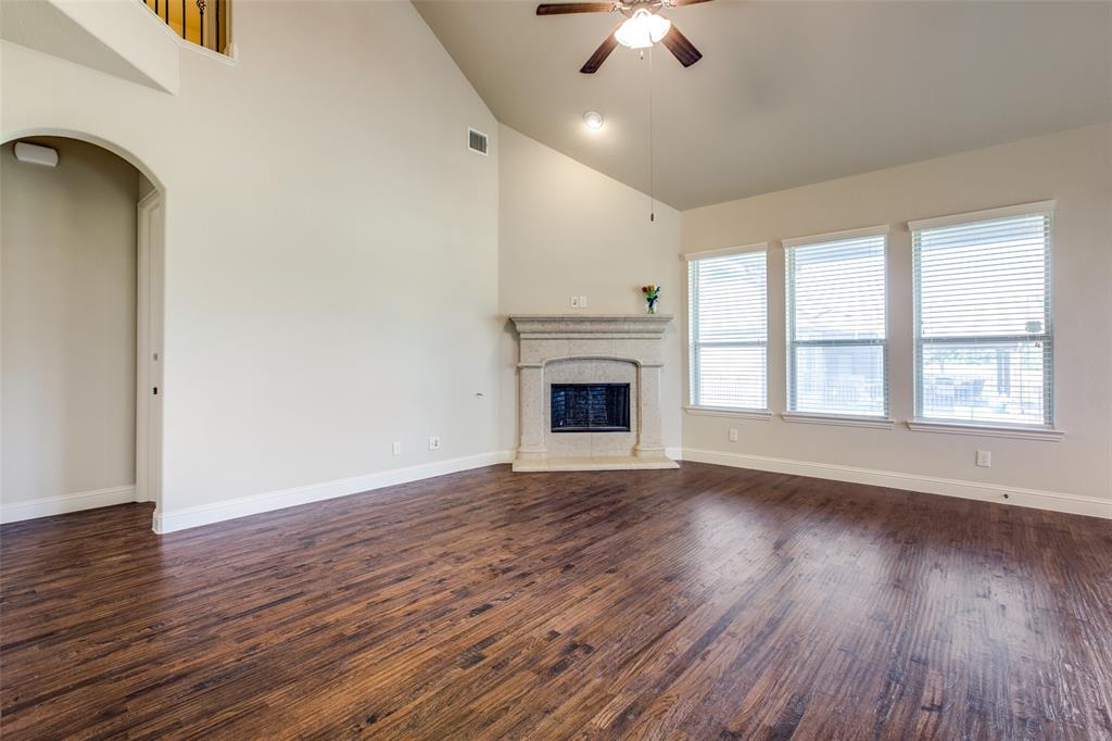 503 Hemlock Court Wylie, TX 75098 - Photo 12 of 35 a view of an empty room with wooden floor fireplace and a window