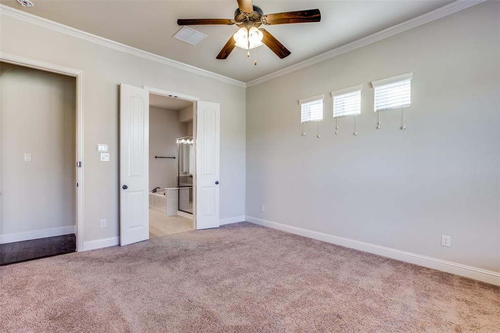 503 Hemlock Court Wylie, TX 75098 - Photo 13 of 35 an empty room with chandelier fan and windows