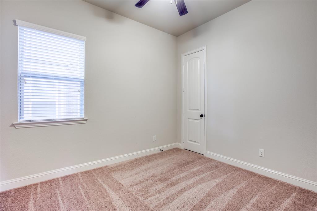 503 Hemlock Court Wylie, TX 75098 - Photo 26 of 35 an empty room with a window and a ceiling fan