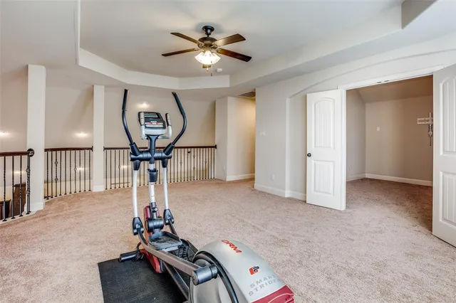 a room with gym equipment and a chandelier