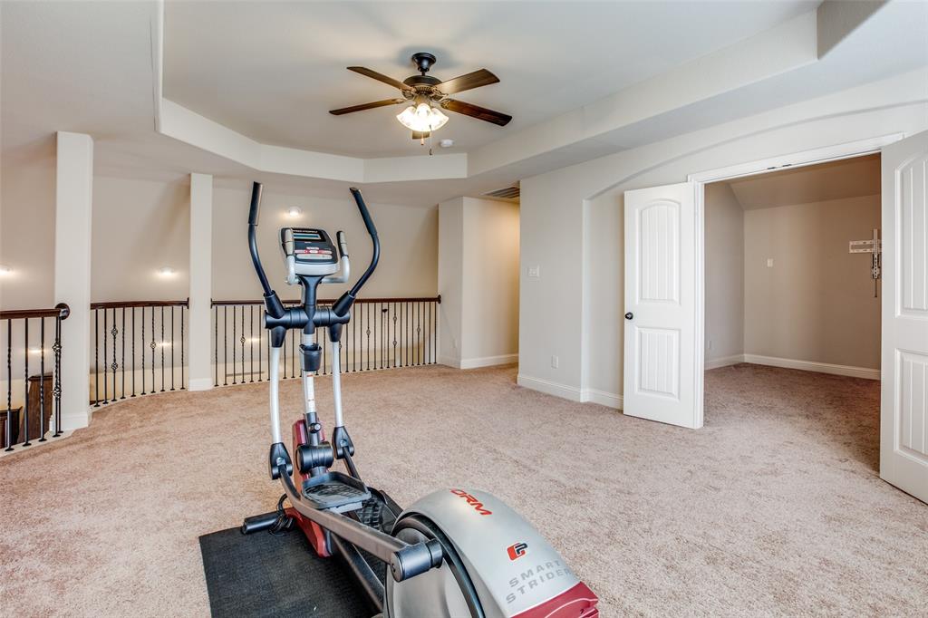 503 Hemlock Court Wylie, TX 75098 - Photo 29 of 35 a room with gym equipment and a chandelier