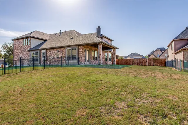 a view of a house with a big yard and large trees