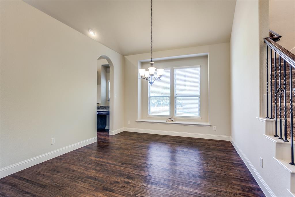 503 Hemlock Court Wylie, TX 75098 - Photo 6 of 35 an empty room with wooden floor and windows