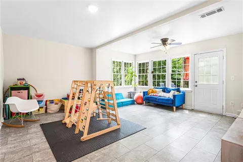 a bedroom with furniture and a large window