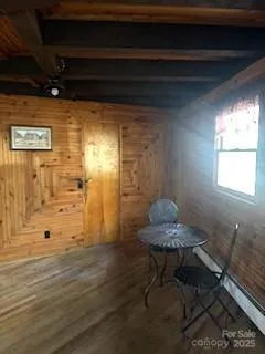 a view of a room with wooden floor and a cabinet