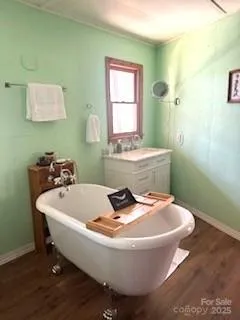 a white bath tub sitting in a bathroom next to a window