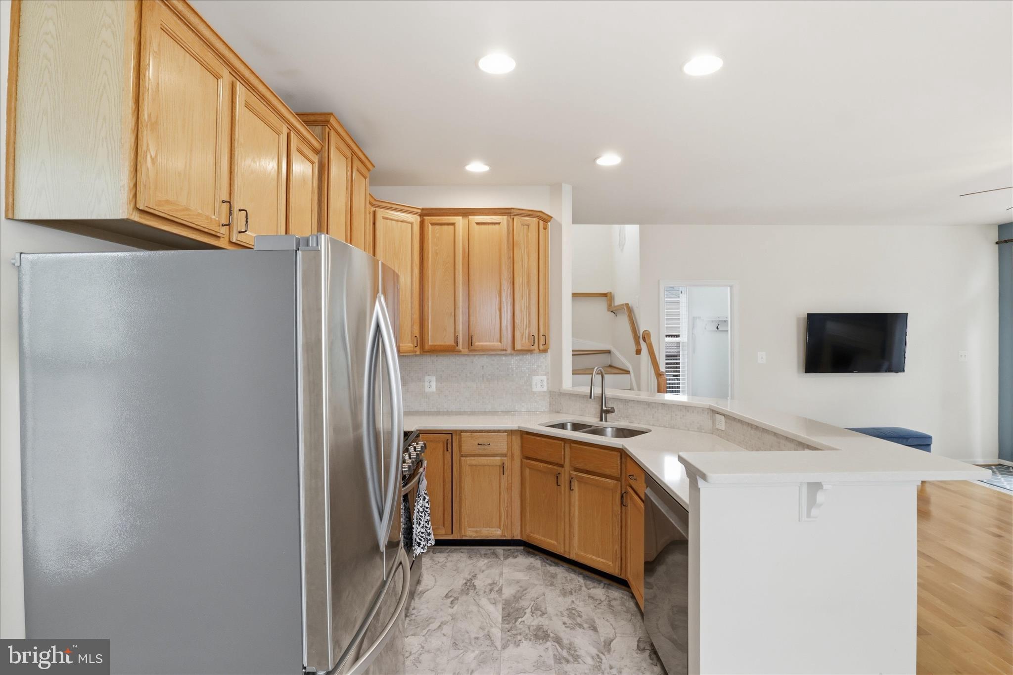 25352 Ripleys Field Drive Chantilly, VA 20152 - Photo 5 of 54 a kitchen with a sink and a refrigerator
