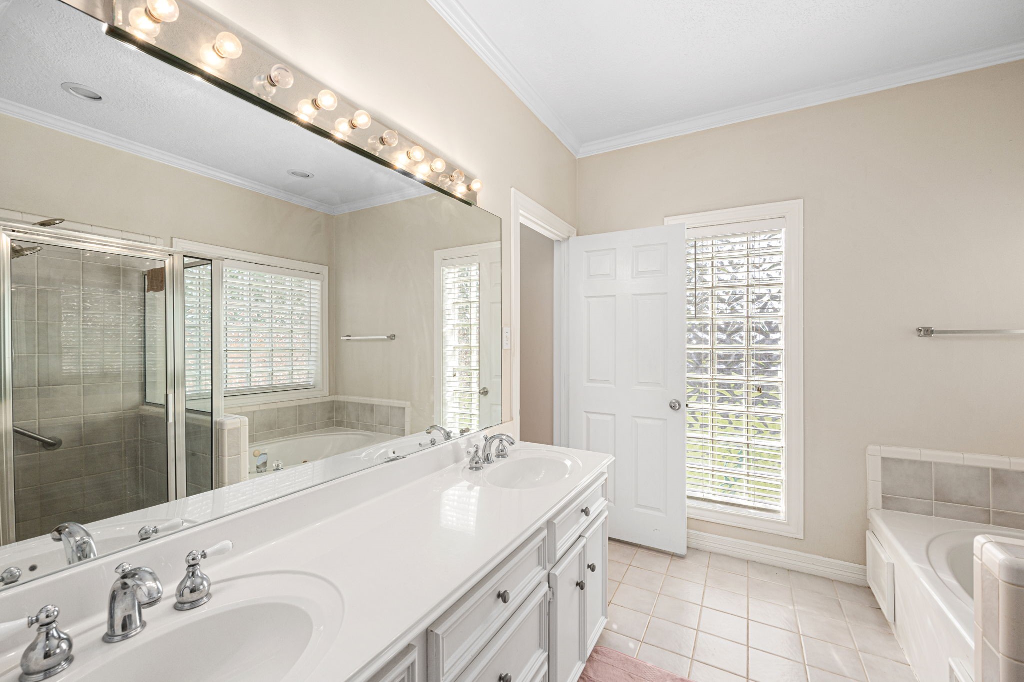 7202 North Fawn River Circle Spring, TX 77379 - Photo 16 of 22 a spacious bathroom with a double vanity sink mirror and shower