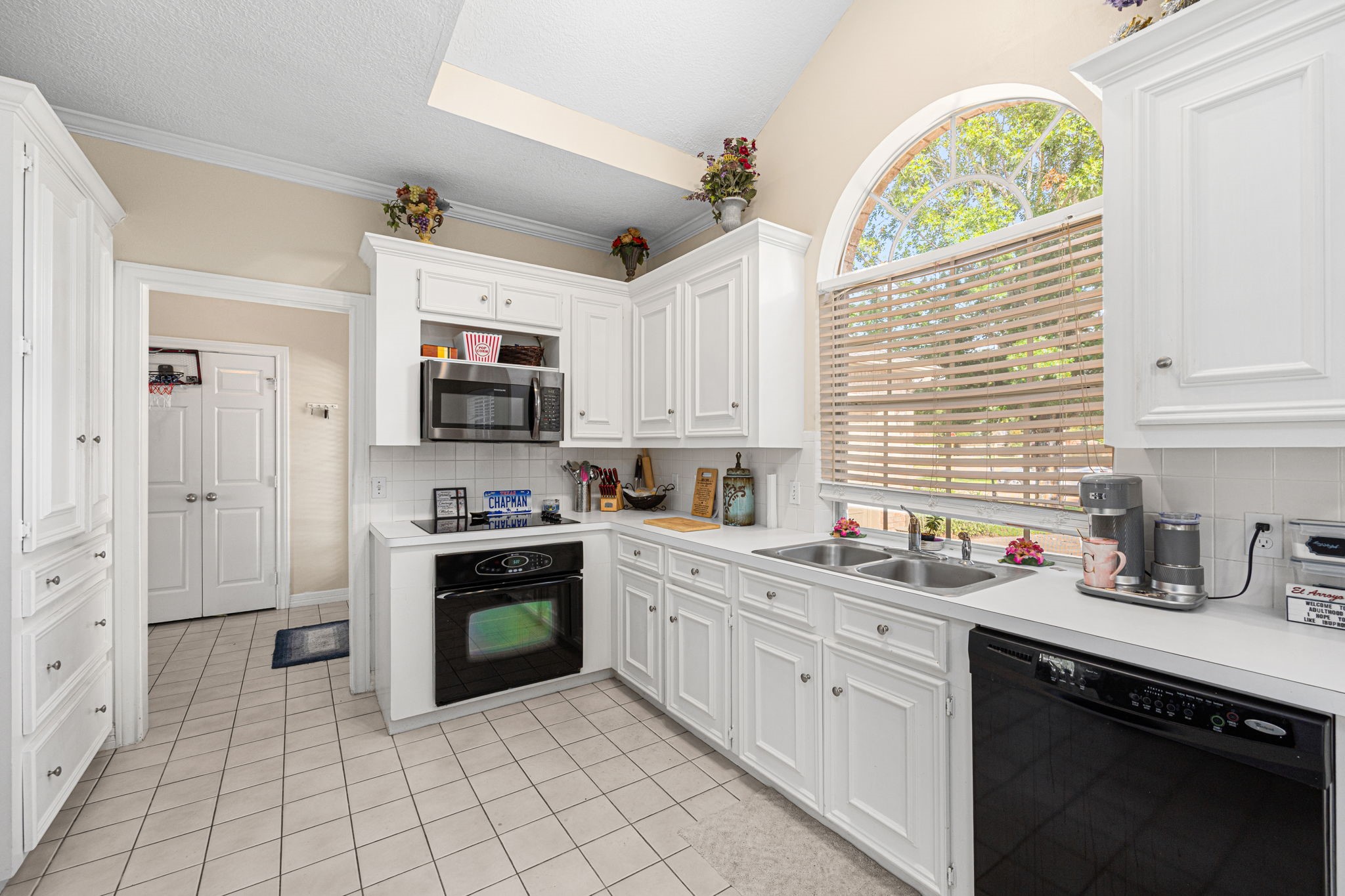 7202 North Fawn River Circle Spring, TX 77379 - Photo 7 of 22 a kitchen with white cabinets and appliances