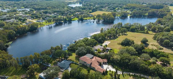 an aerial view of residential house with outdoor space and lake view