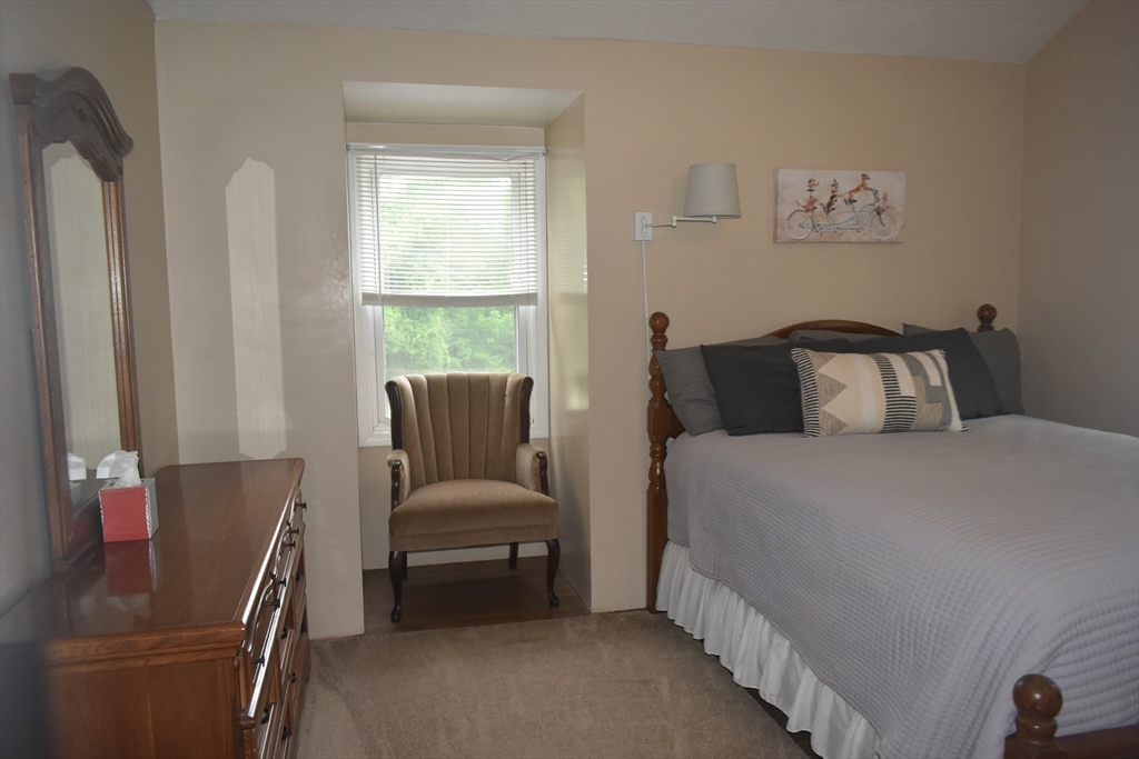 111 Northwest Road Spencer, MA 01562 - Photo 21 of 34 a bedroom with a bed and a couch with window