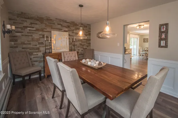 a view of a dining room with furniture wooden floor and chandelier