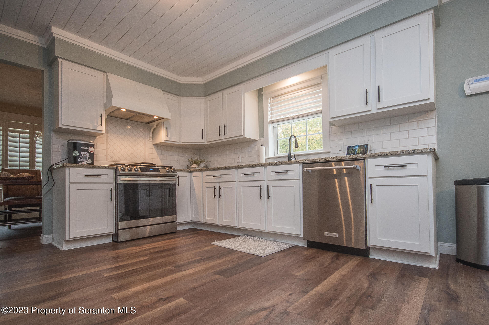 34 Blackberry Hill Road Moscow, PA 18444 - Photo 16 of 43 a kitchen with granite countertop wooden floors and white stainless steel appliances