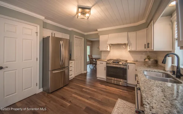 a kitchen with a refrigerator sink and cabinets