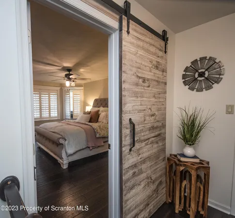 a bedroom with a bed and a potted plant
