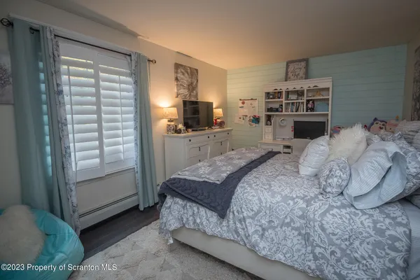a bedroom with a large bed and a window