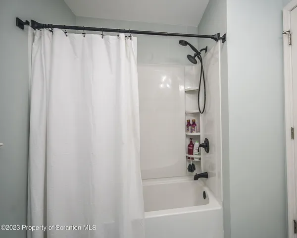 a bathroom with a shower and a bath tub