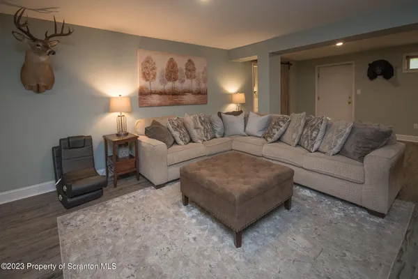 a living room with furniture and a lamp
