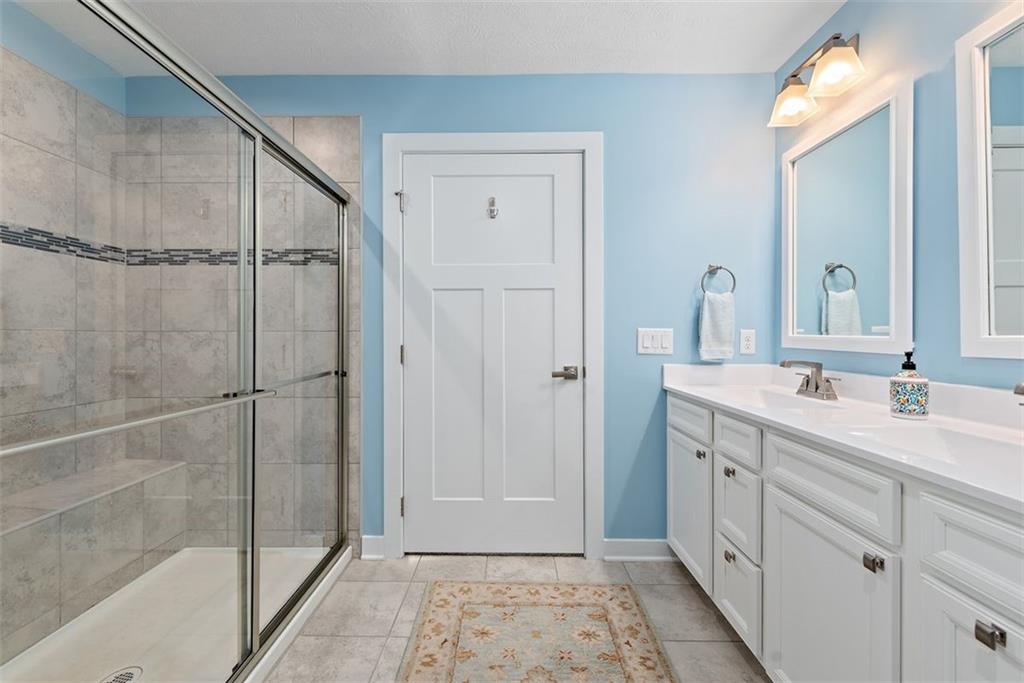 508 Hogan Drive Monroeville, PA 15146 - Photo 20 of 26 a bathroom with a double vanity sink a mirror and shower