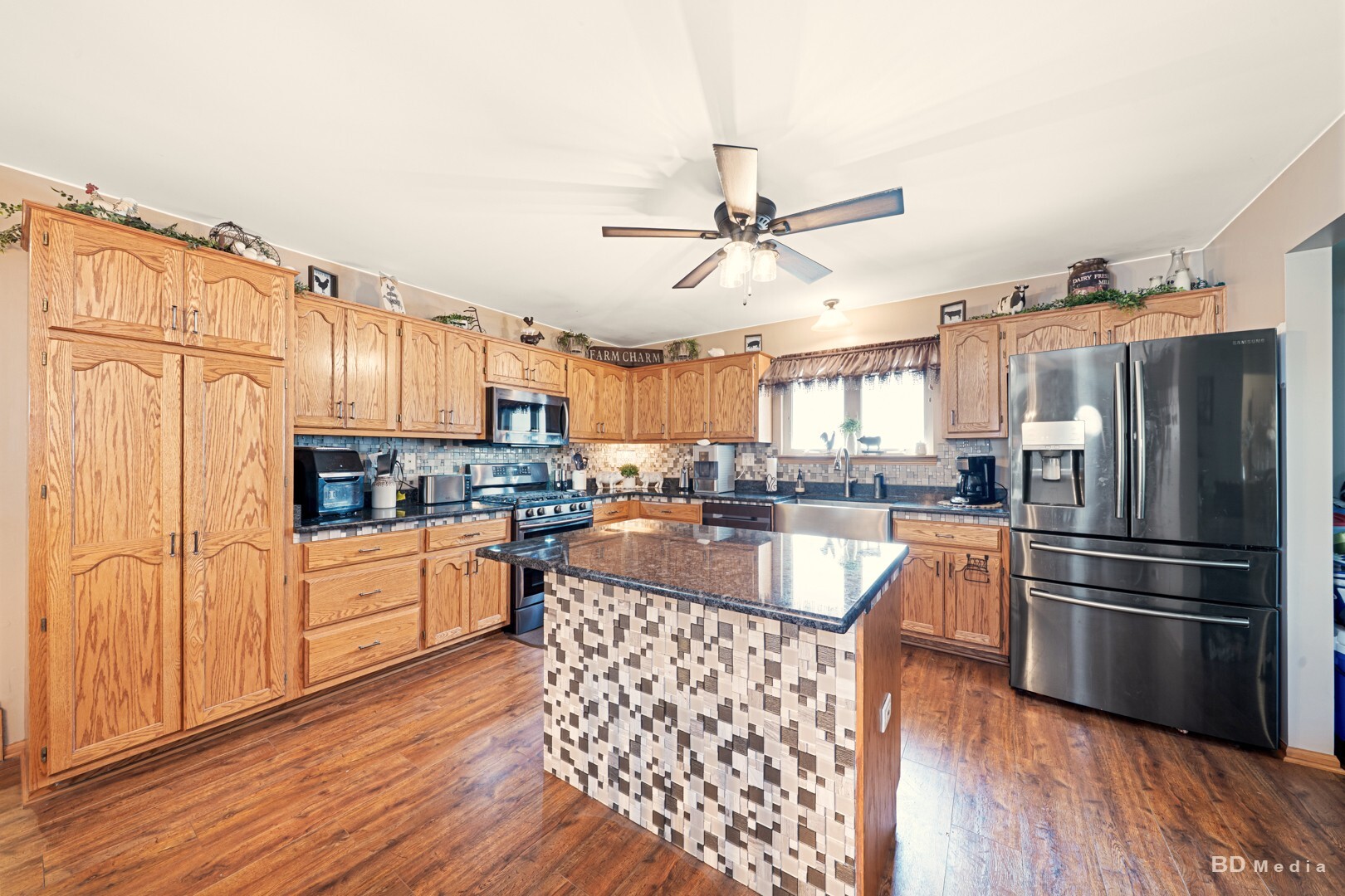 2018 Olde Mill Road Plainfield, IL 60586 - Photo 7 of 30 a large kitchen with cabinets wooden floor and stainless steel appliances