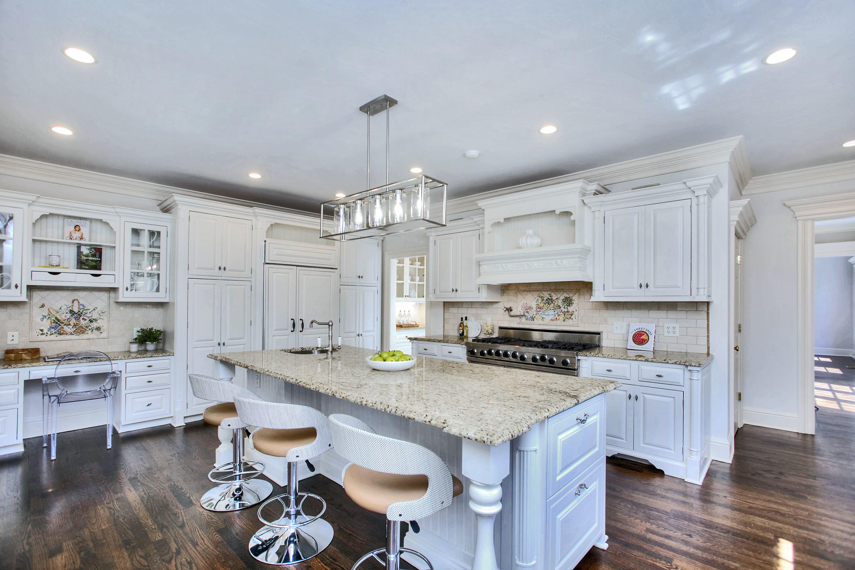 320 Ponus Ridge Road New Canaan, CT 06840 - Photo 14 of 40 a kitchen with a sink a stove and chairs with wooden floor