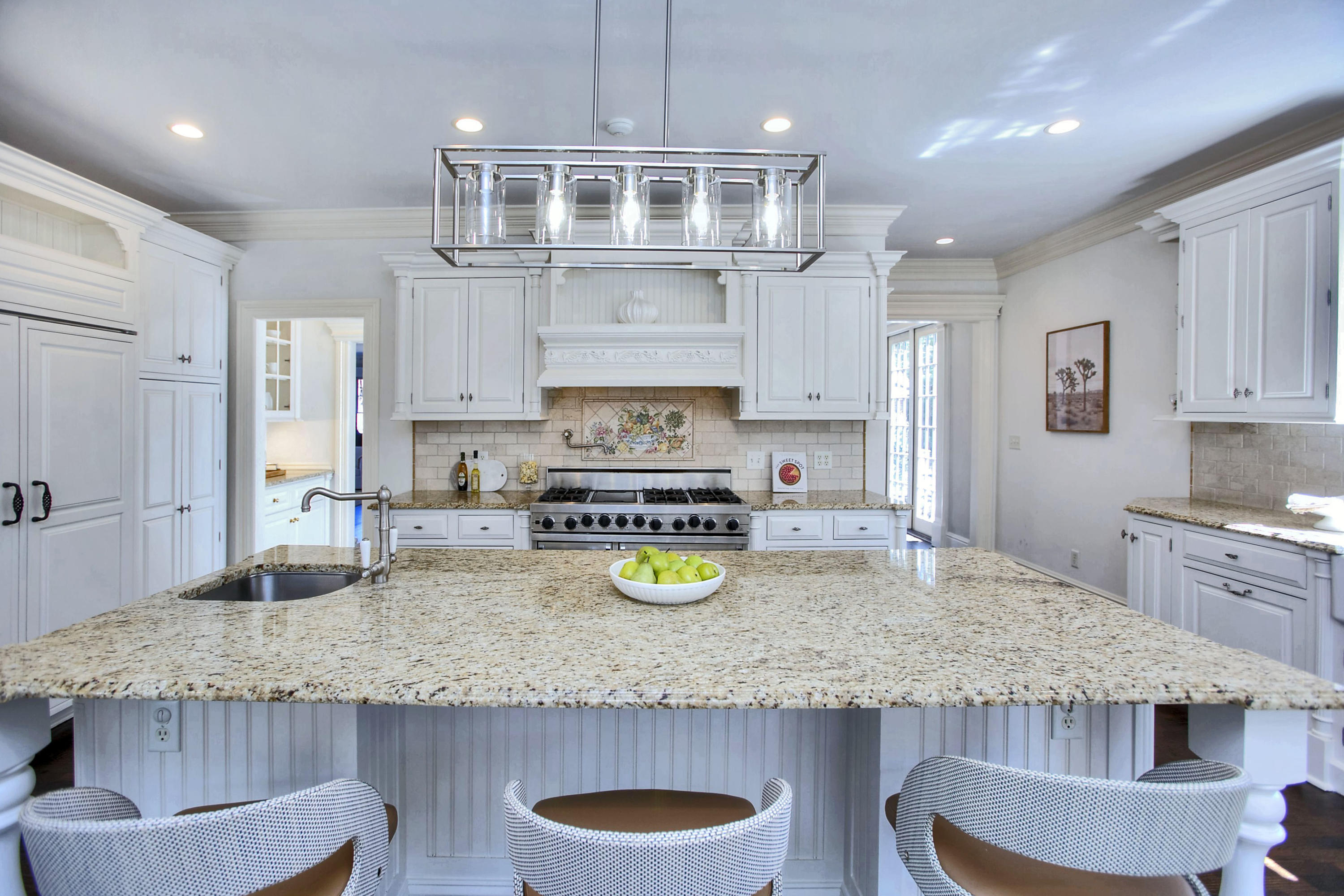 320 Ponus Ridge Road New Canaan, CT 06840 - Photo 15 of 40 a kitchen with granite countertop a sink a stove and cabinets