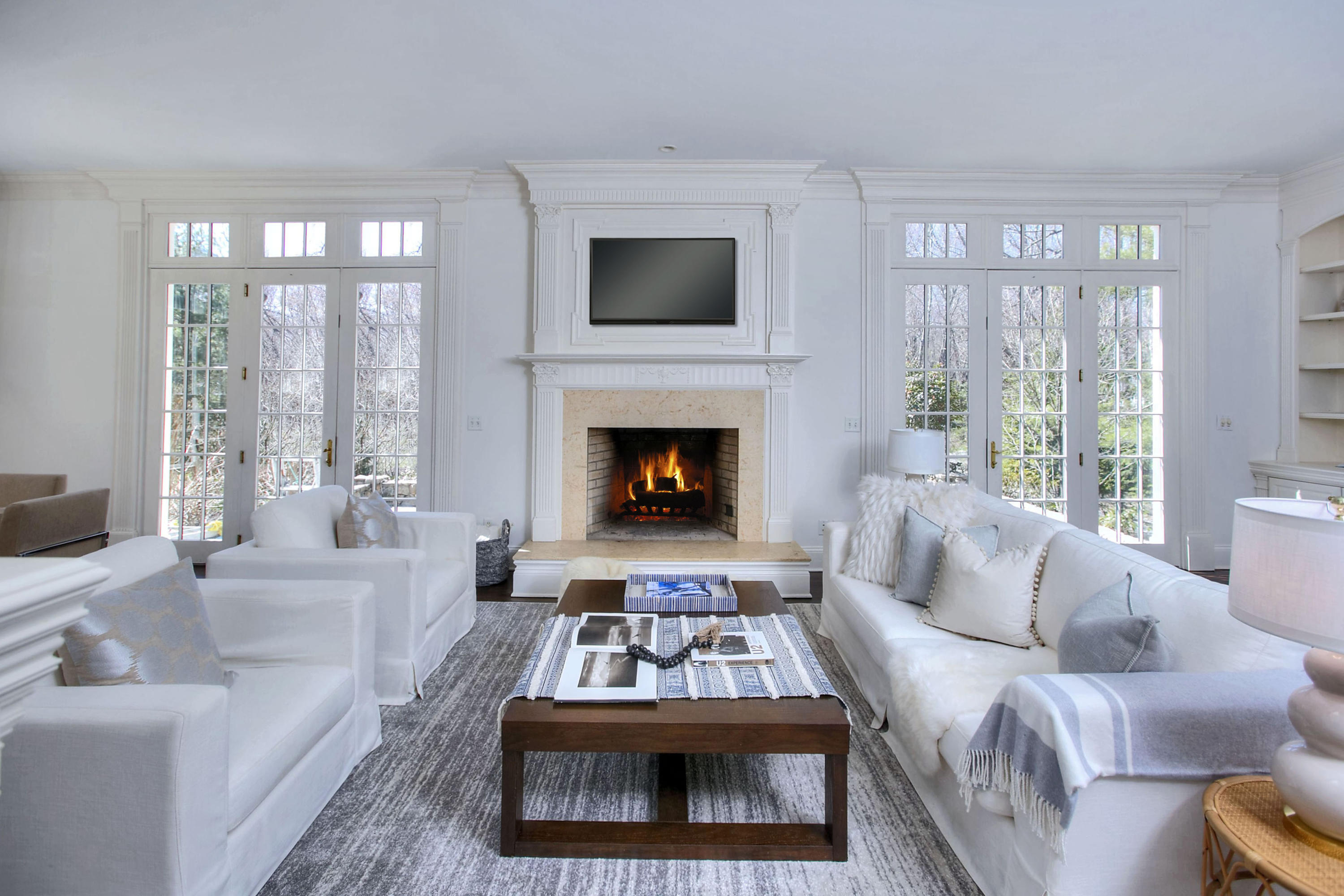 320 Ponus Ridge Road New Canaan, CT 06840 - Photo 17 of 40 a living room with furniture and a fireplace