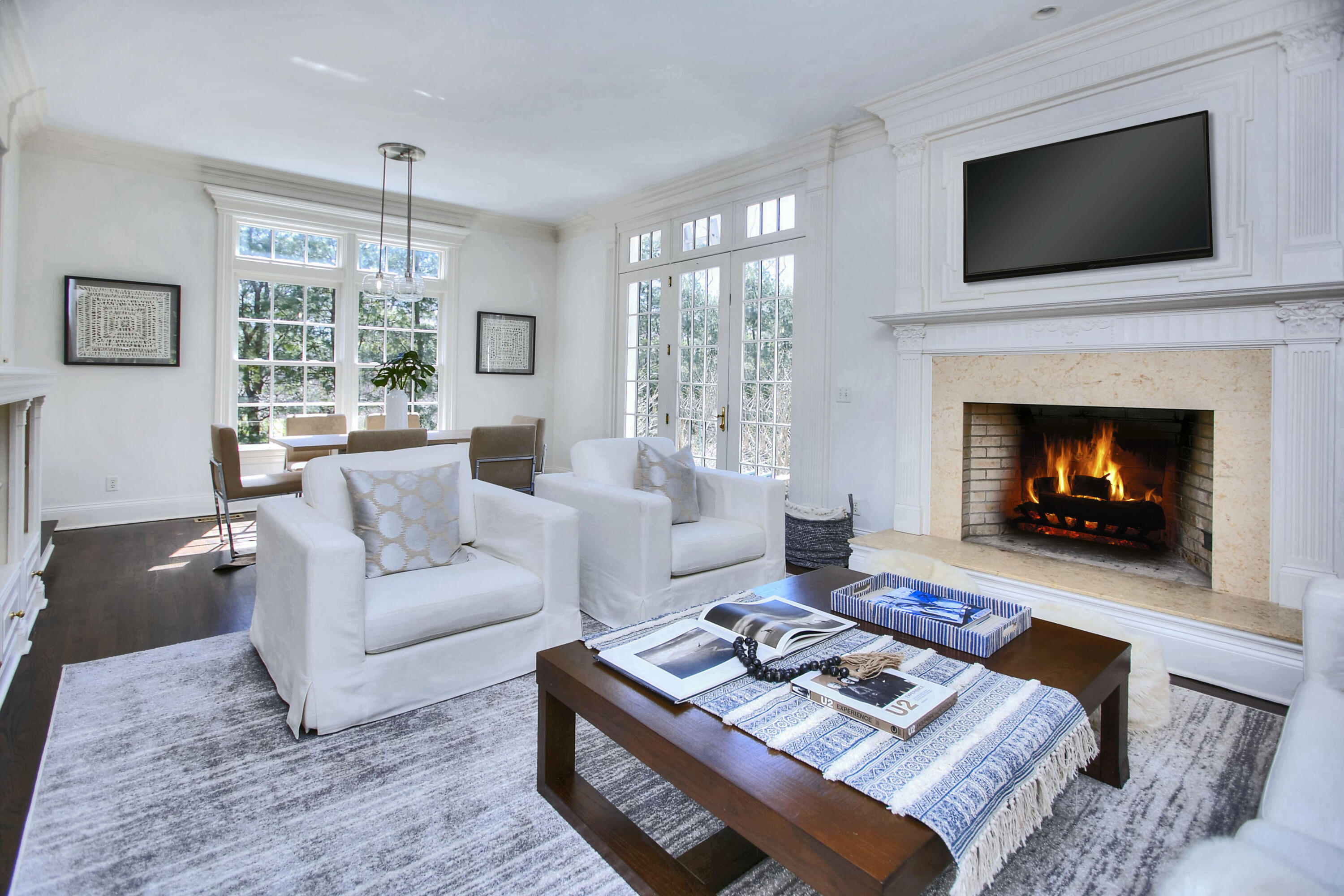 320 Ponus Ridge Road New Canaan, CT 06840 - Photo 18 of 40 a living room with furniture a flat screen tv and a fireplace