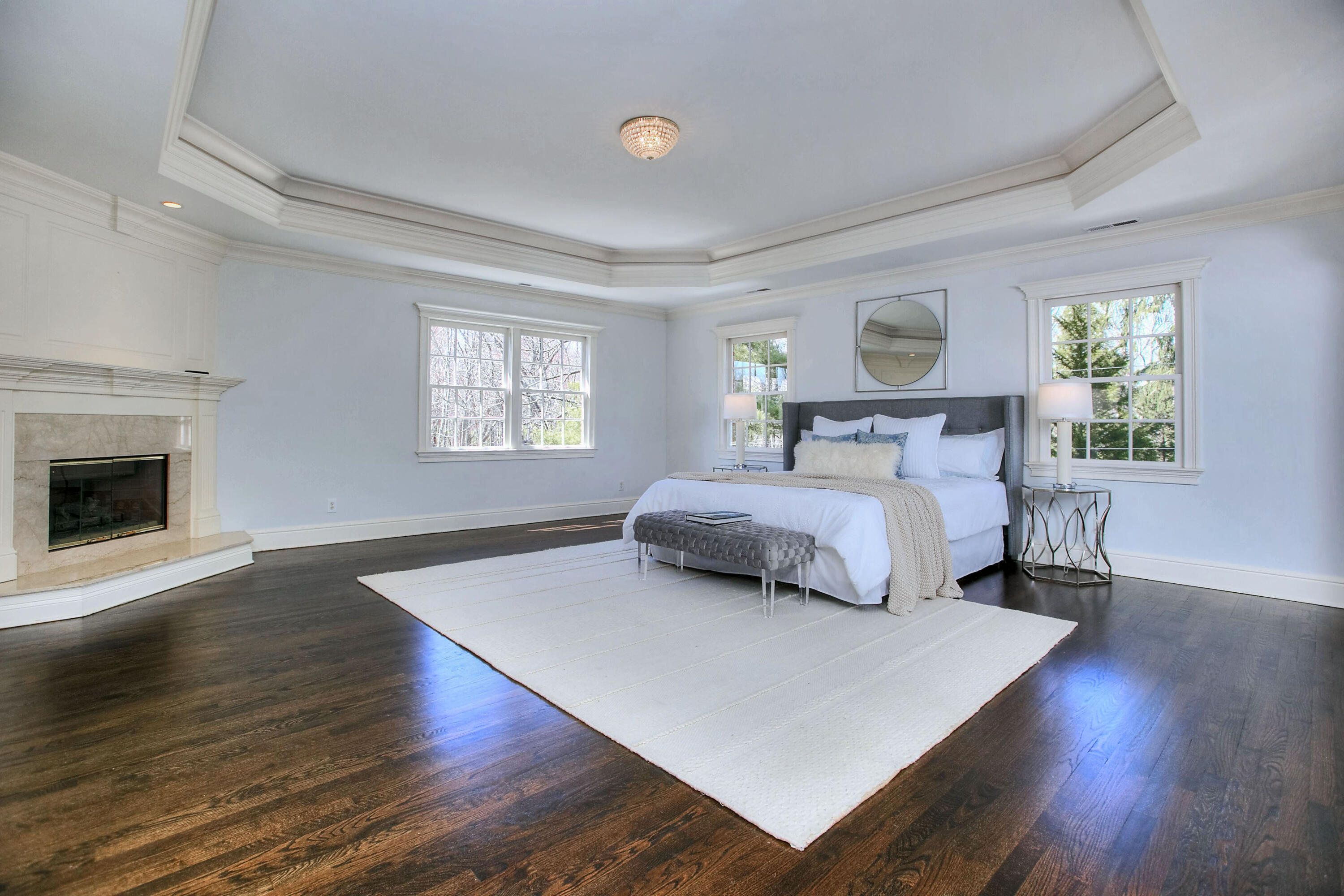 320 Ponus Ridge Road New Canaan, CT 06840 - Photo 23 of 40 a bedroom with a large bed and a fireplace