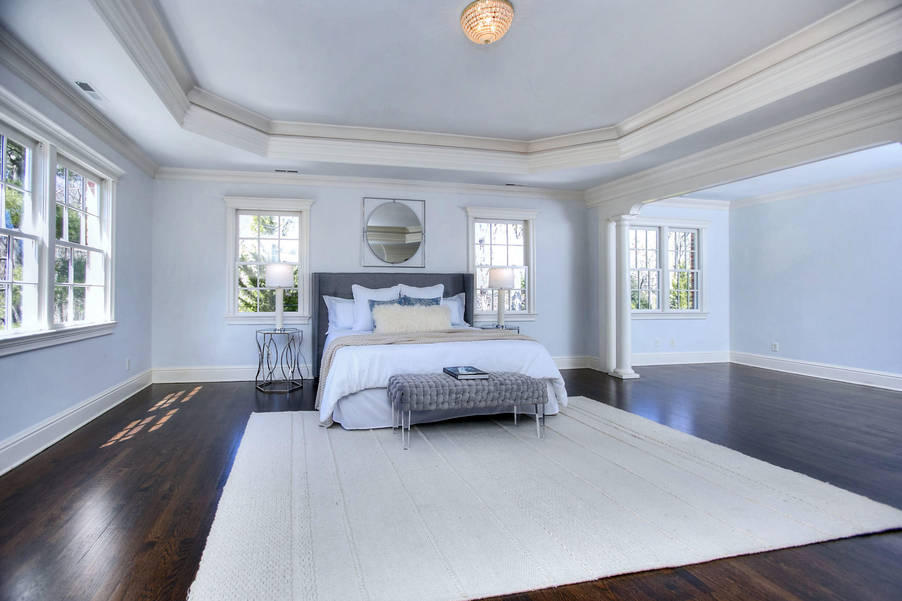 320 Ponus Ridge Road New Canaan, CT 06840 - Photo 26 of 40 a bedroom with a large bed and wooden floor