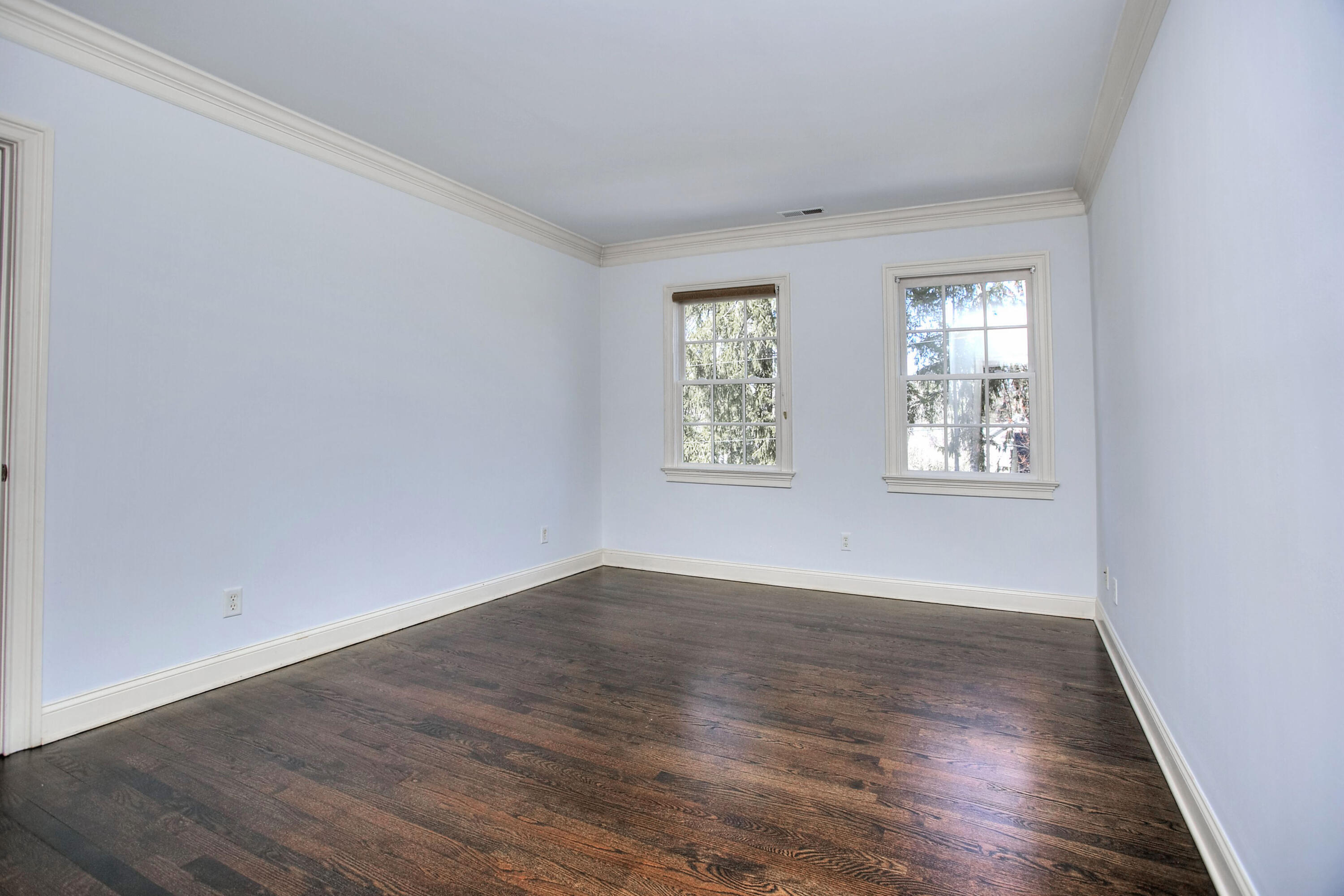 320 Ponus Ridge Road New Canaan, CT 06840 - Photo 29 of 40 an empty room with wooden floor and windows