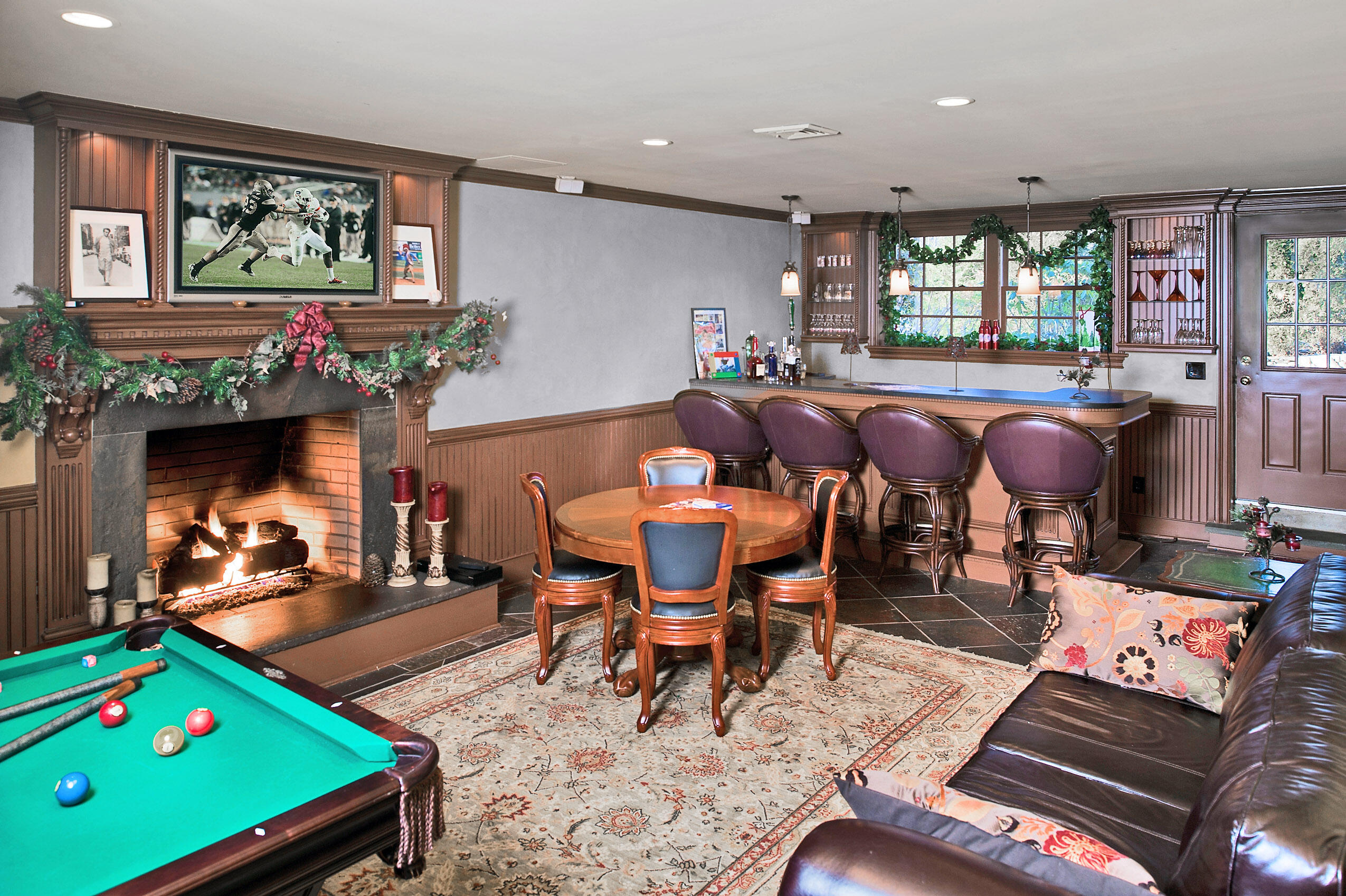 320 Ponus Ridge Road New Canaan, CT 06840 - Photo 32 of 40 a living room with furniture a flat screen tv and a table