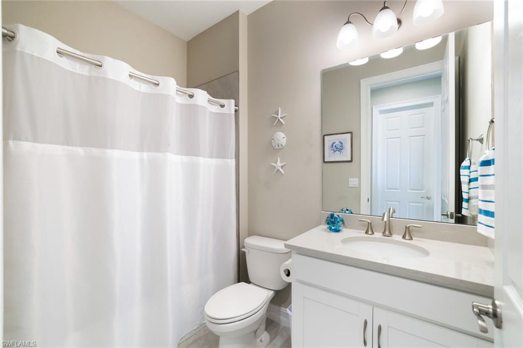 1116 Rolling Brook Lane Naples, FL 34114 - Photo 14 of 22 a bathroom with a sink vanity mirror and toilet