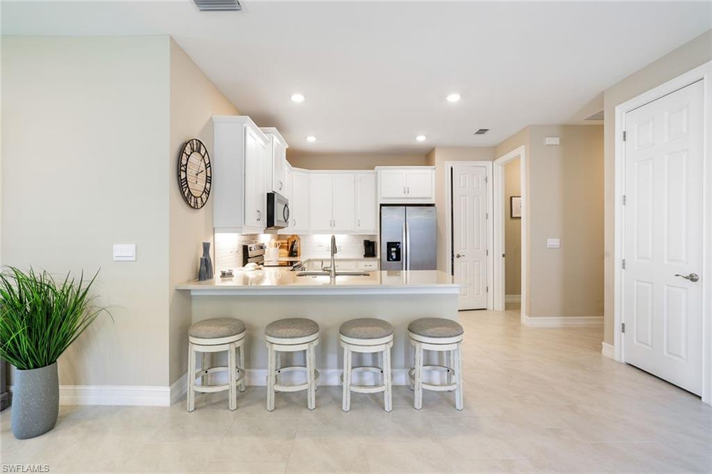 1116 Rolling Brook Lane Naples, FL 34114 - Photo 7 of 22 a kitchen with a table and chairs in it