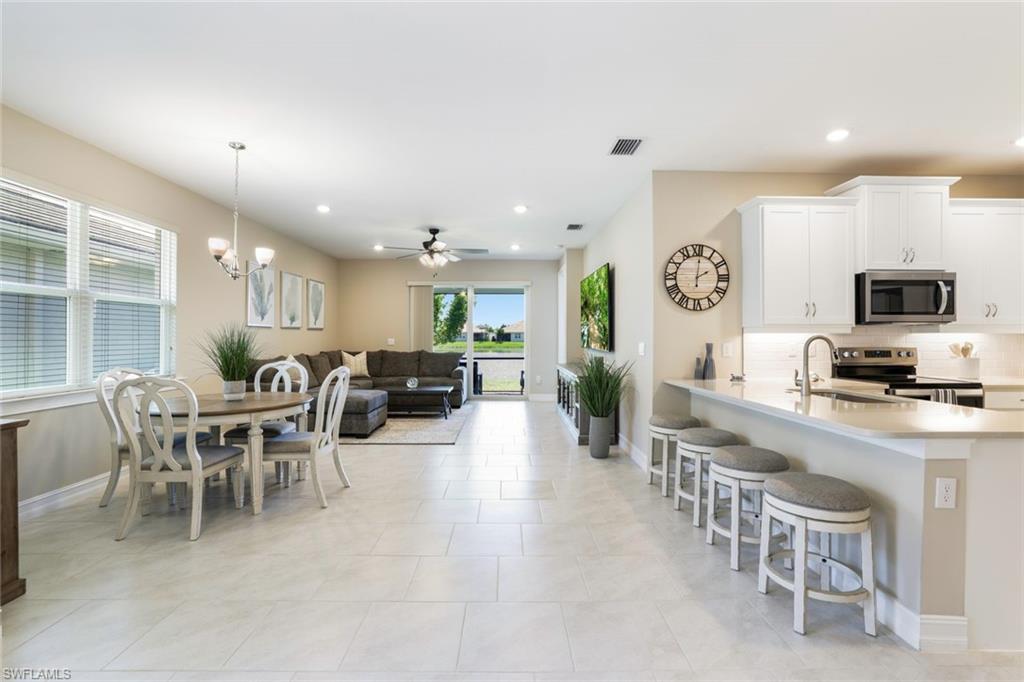 1116 Rolling Brook Lane Naples, FL 34114 - Photo 8 of 22 a large kitchen with a table and chairs
