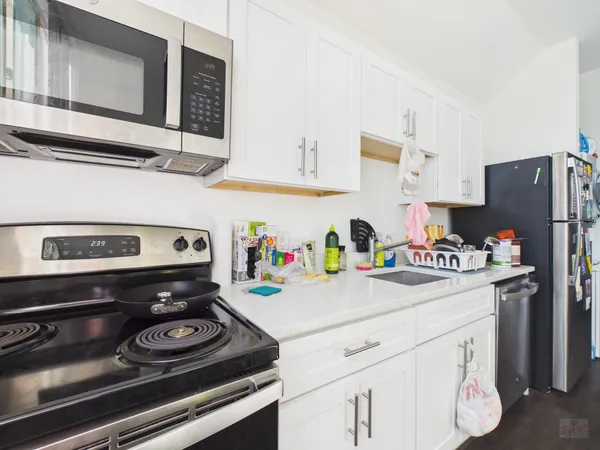 a bathroom with a sink a toilet and a shower curtain