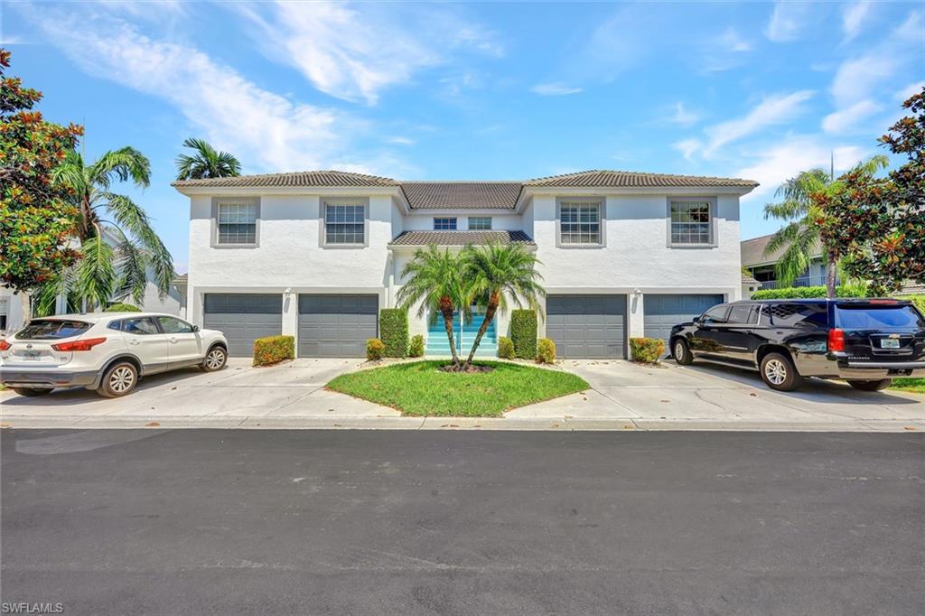 995 Partridge Circle, Unit 202 Naples, FL 34104 - Photo 1 of 27 a couple of cars parked in front of a house