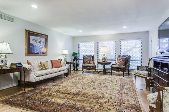 a living room with furniture and a dining table