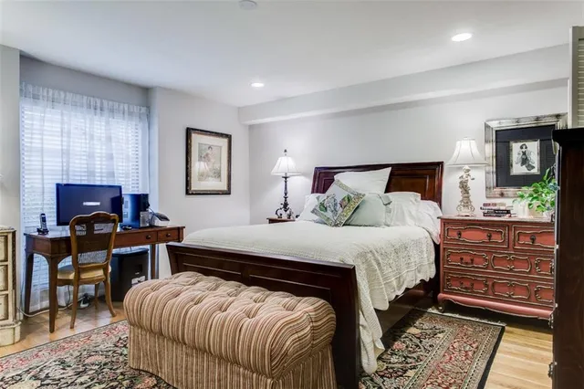 a bedroom with a large bed and dresser