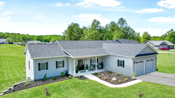 a aerial view of a house with a yard table and chairs