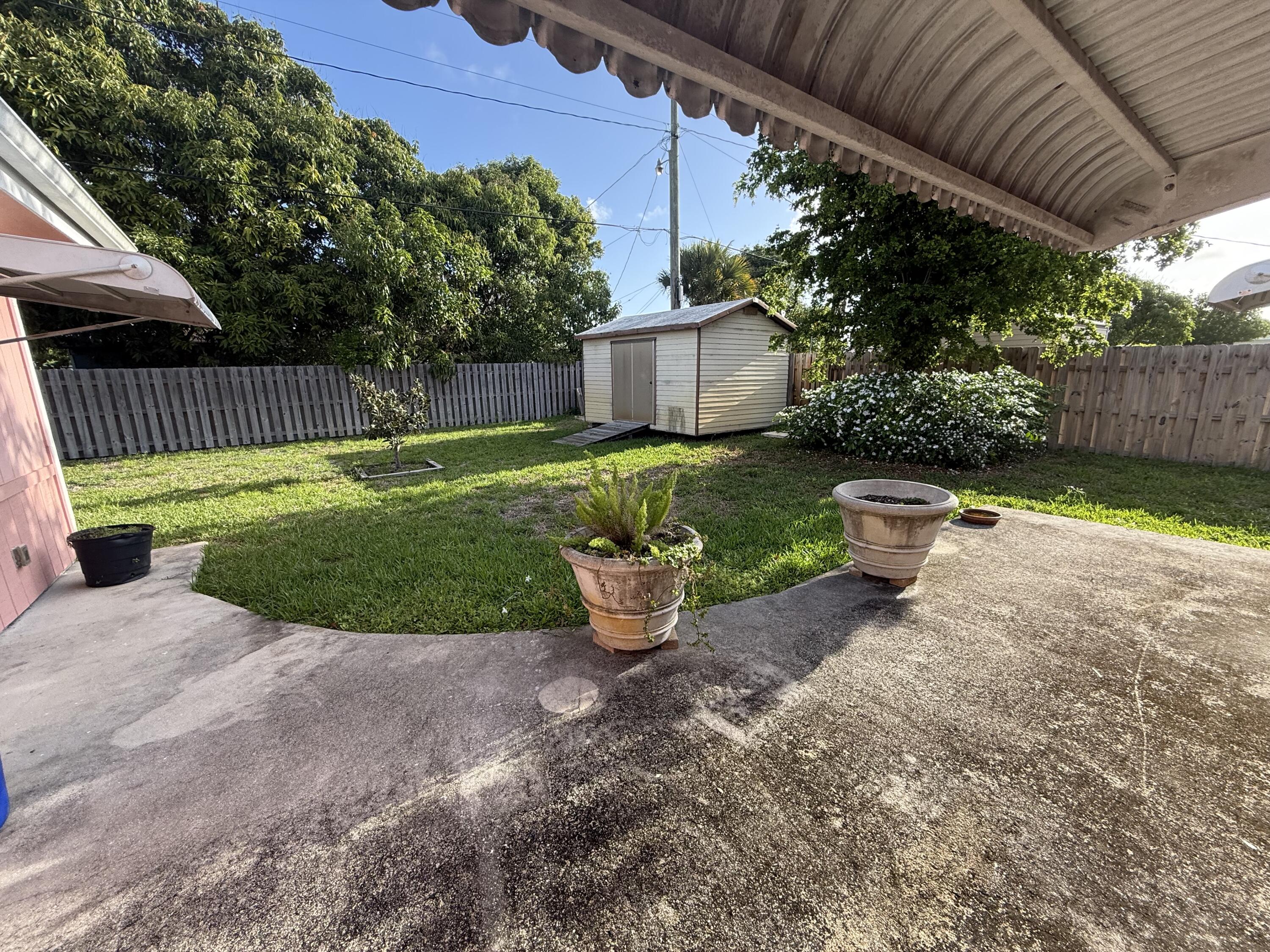 817 Elm Road West Palm Beach, FL 33409 - Photo 4 of 4 a view of a backyard with plants and a patio