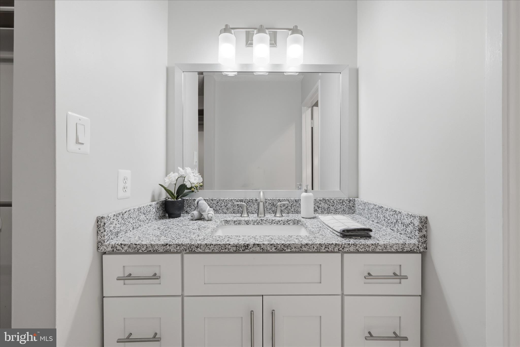 1907 Villaridge Drive Reston, VA 20191 - Photo 14 of 32 a bathroom with a granite countertop sink and a mirror