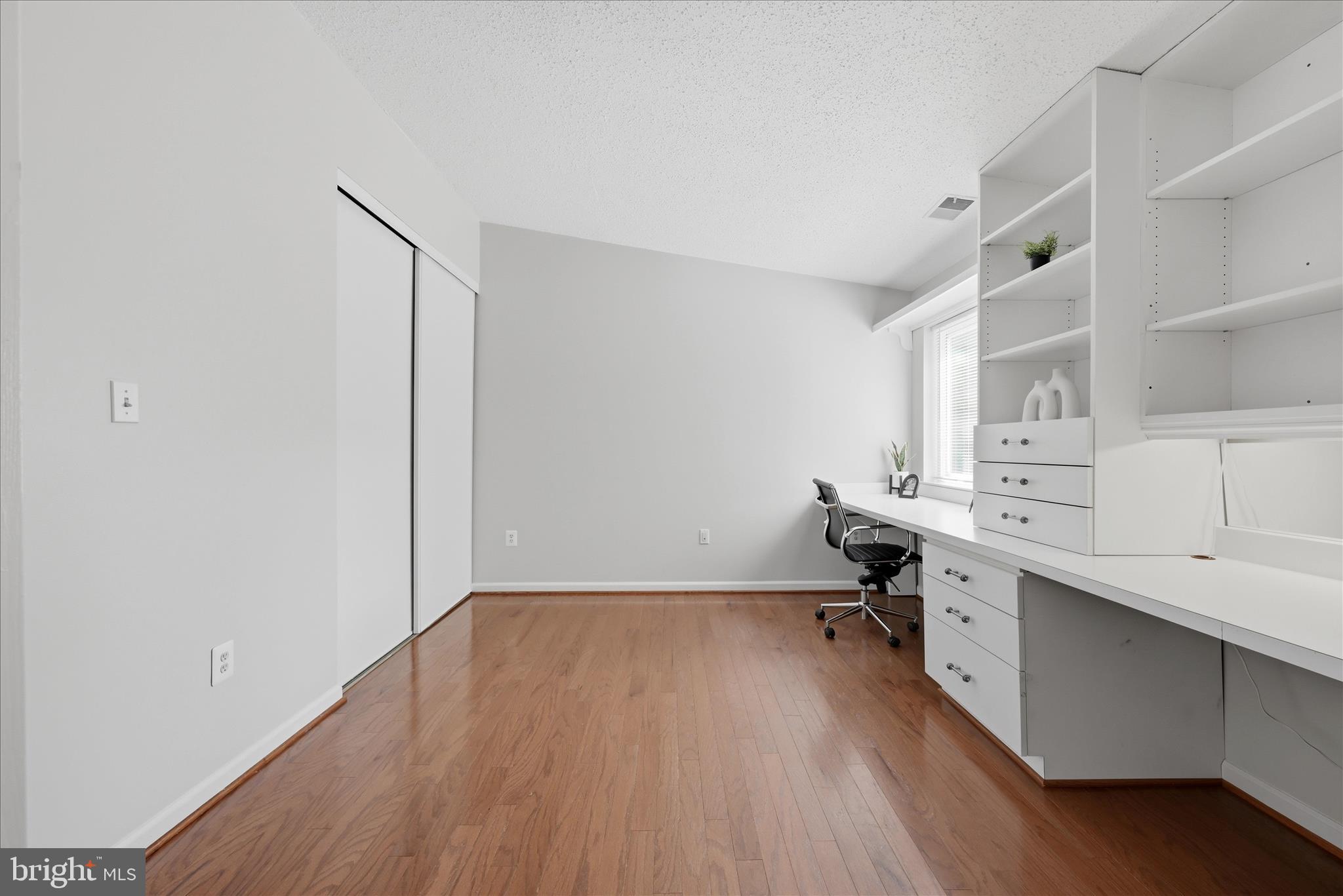 1907 Villaridge Drive Reston, VA 20191 - Photo 17 of 32 a room with a wooden floor and a workspace